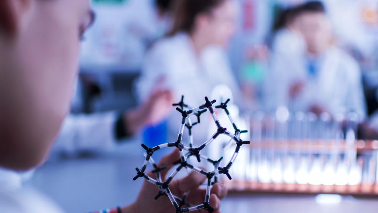 Close up of a student examining molecular structure