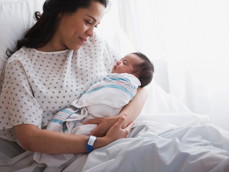 Smiling mother holding baby