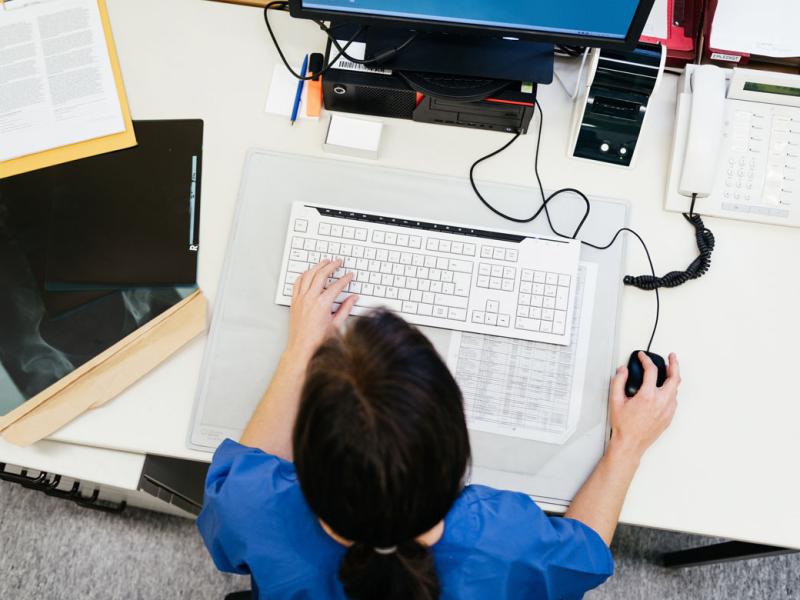 Overhead view of a health care worker at a computer