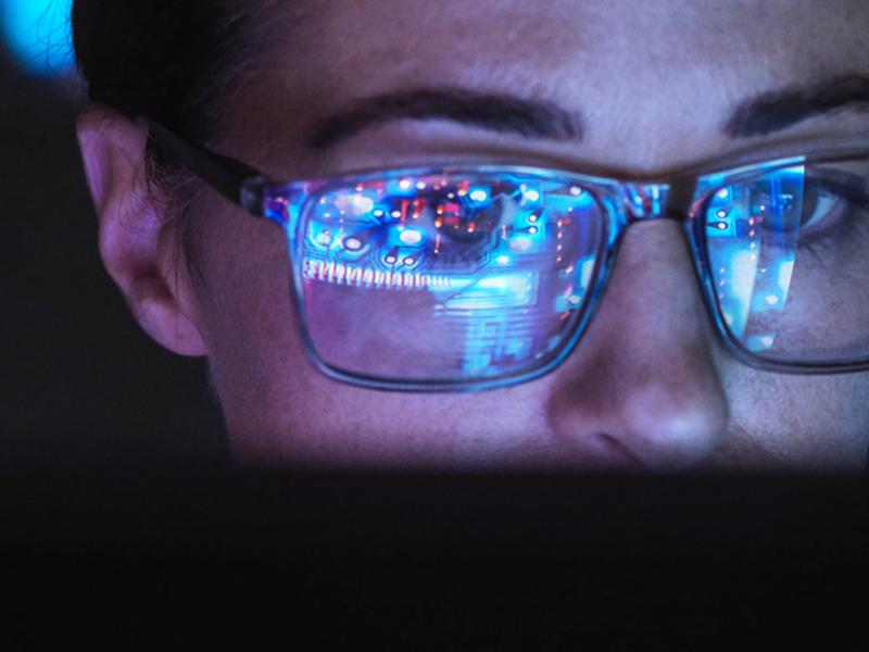 Computer screen reflected in a person's glasses