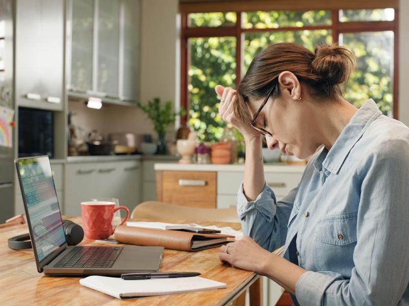 Frustrated woman with head in hand