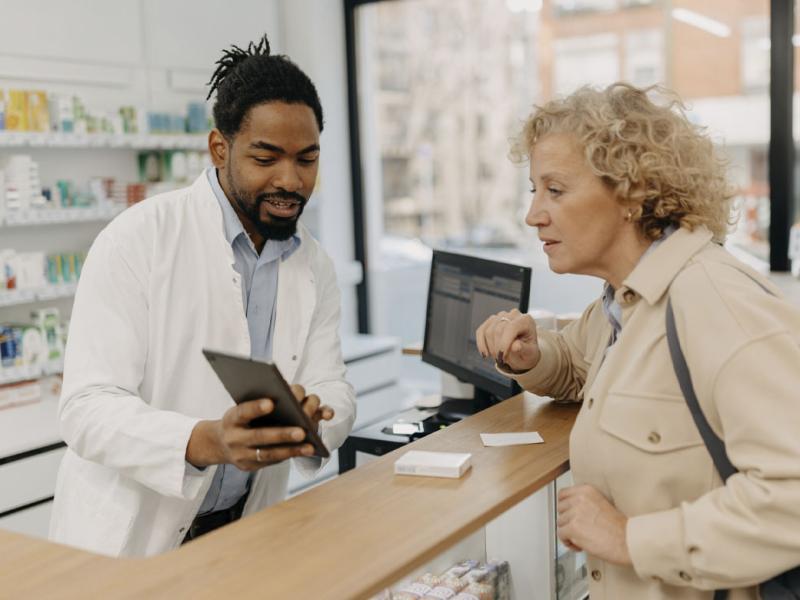 Pharmacist consulting with a customer