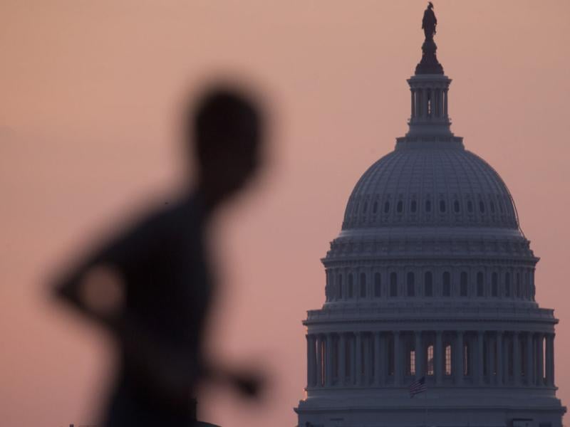 A man jogs past the U.S. Capitol 