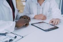 Two doctors using a digital tablet during a discussion