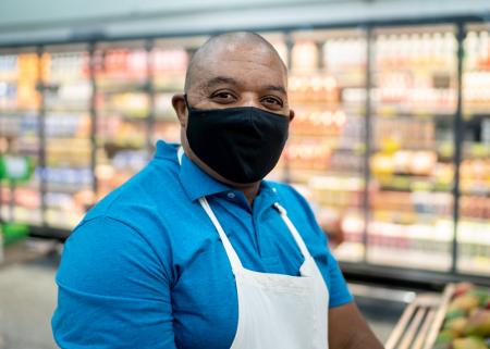 Grocery store employee with a mask