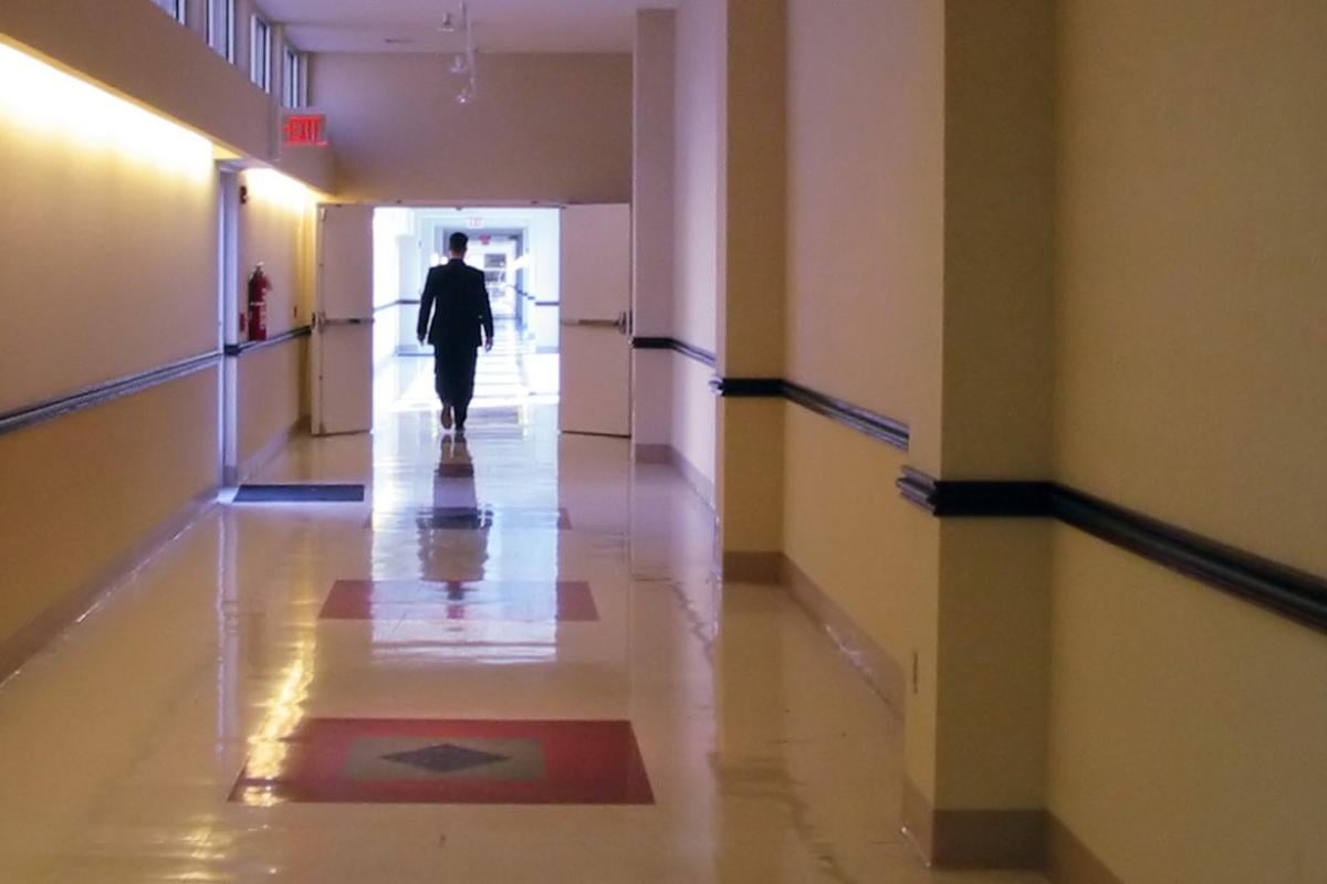 Person walking down hospital hallway