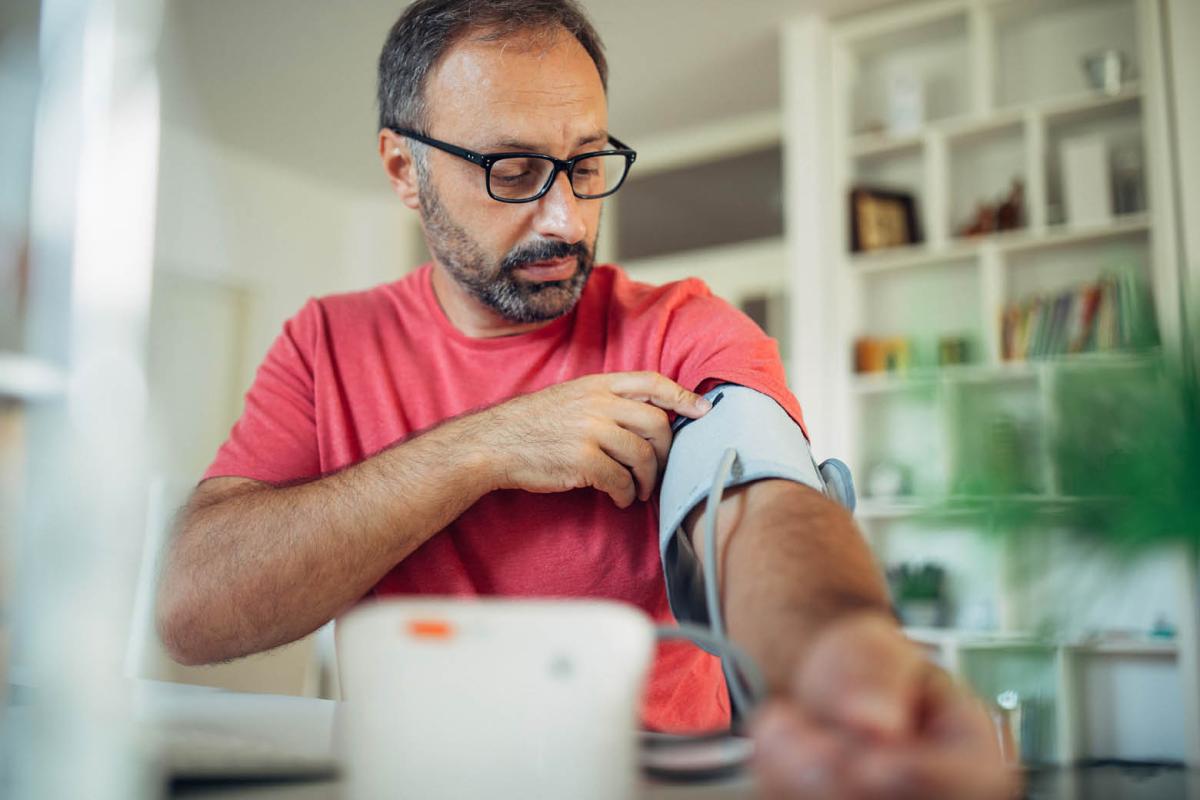 Man measuring his blood pressure at home
