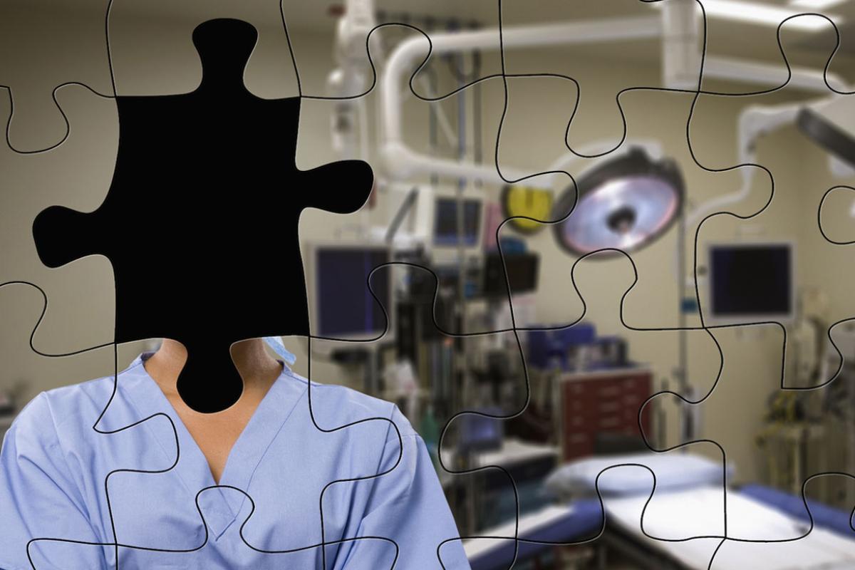 Puzzle picture of physician with missing piece representing face