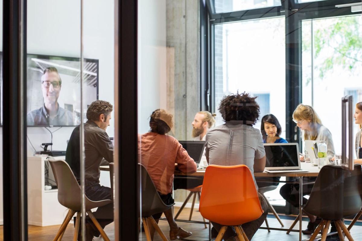 Group conducting video conference meeting