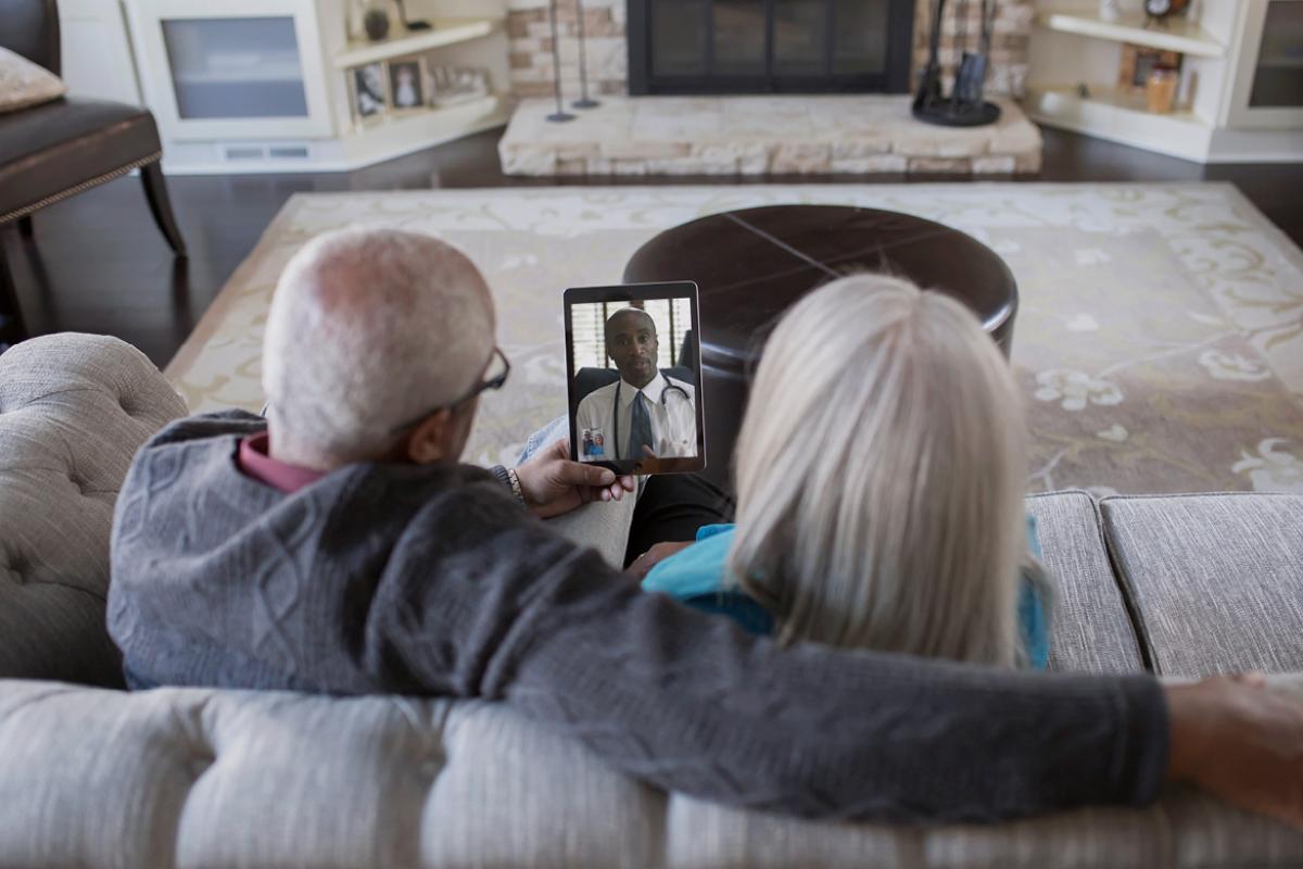 Patients at home looking at computer tablet