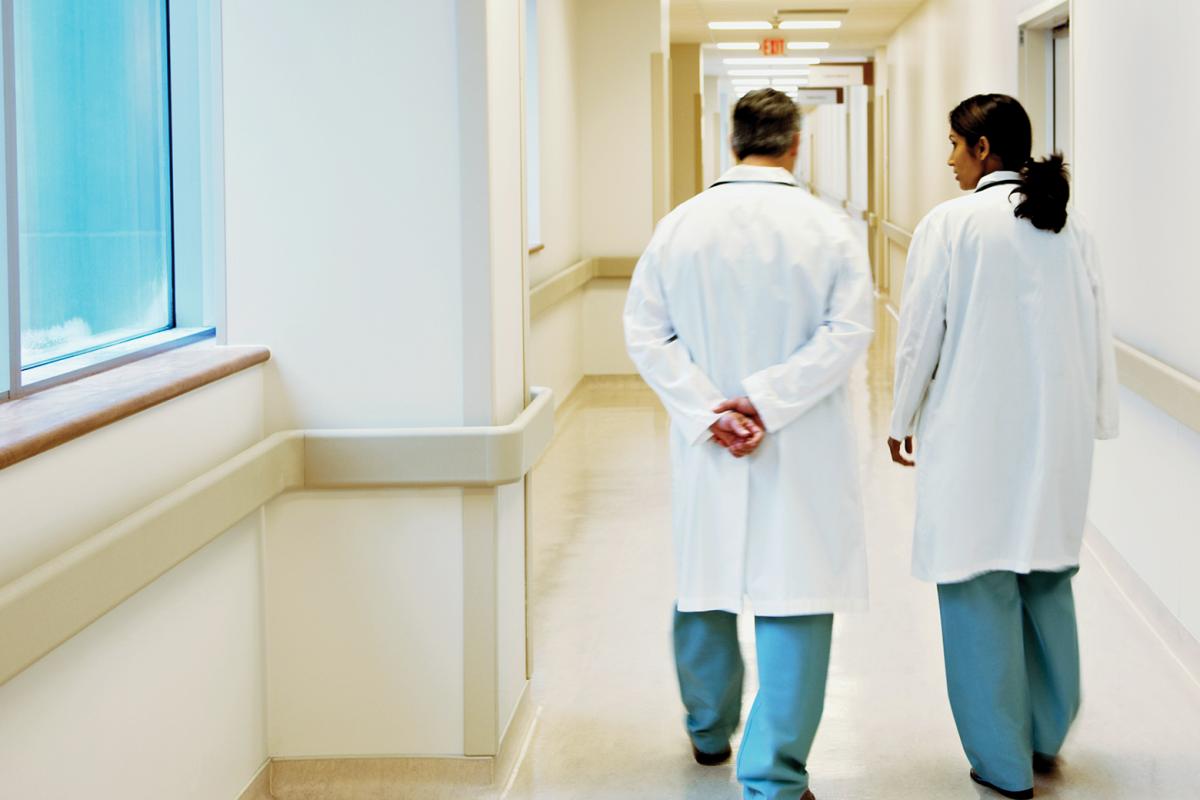 Two physicians walking together and having a conversation