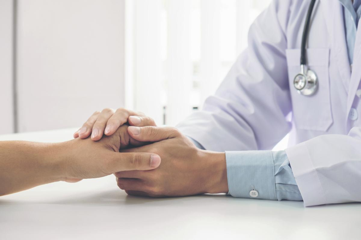 Physician holding a patient's hand