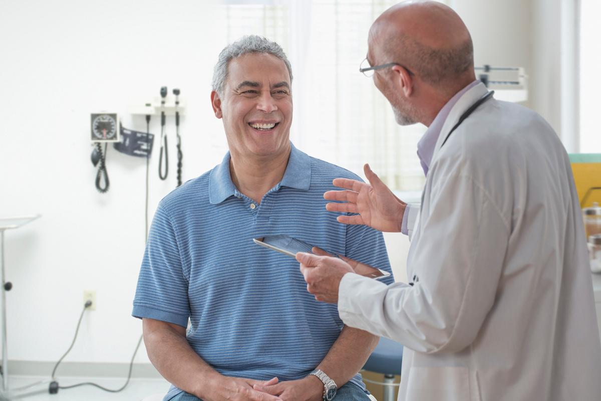 Physician talking with a smiling patient