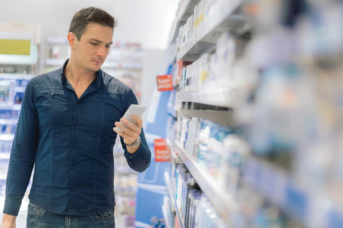 Man in pharmacy looking at a prescription
