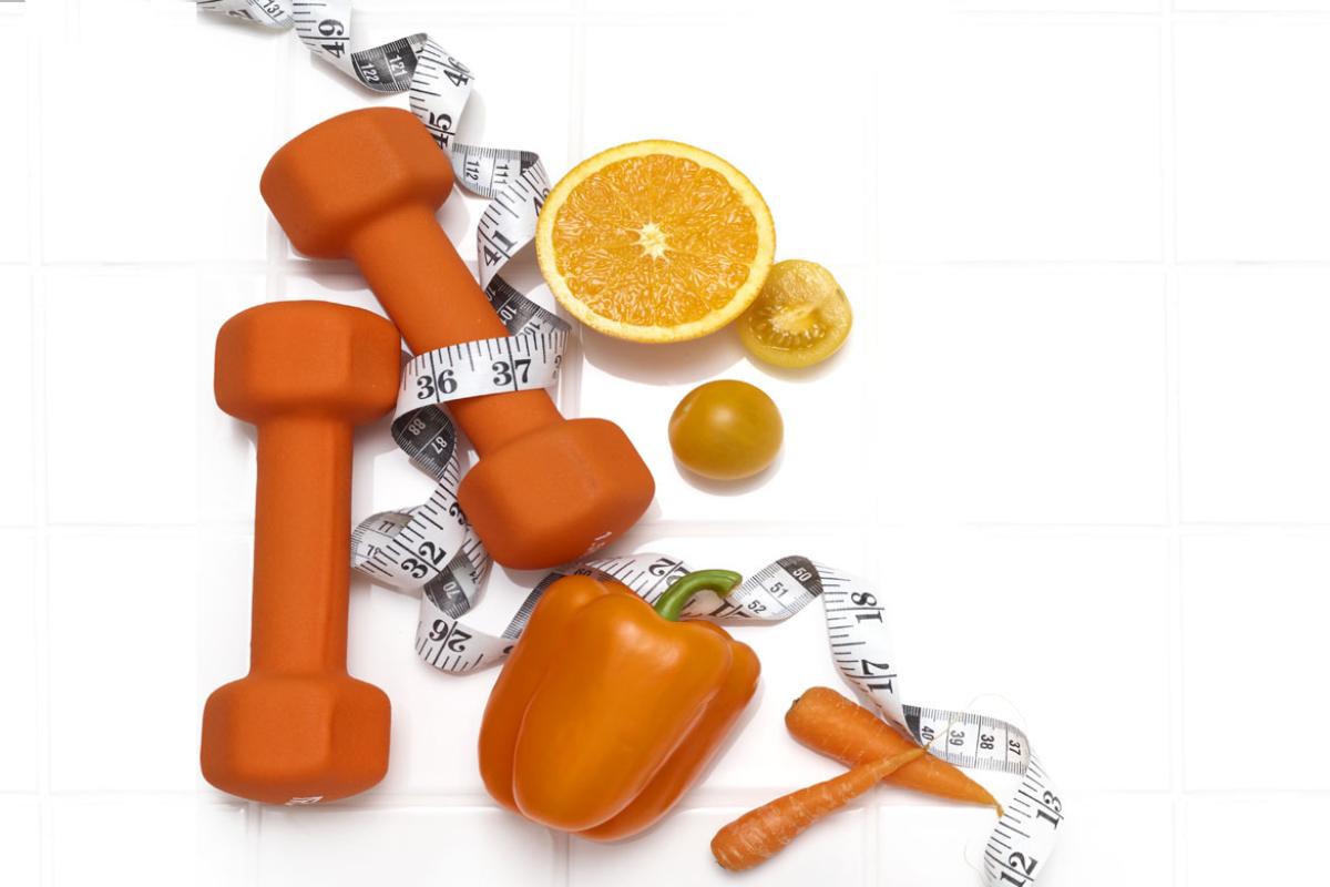 Weights, tape measure, fruits, and vegetables grouped