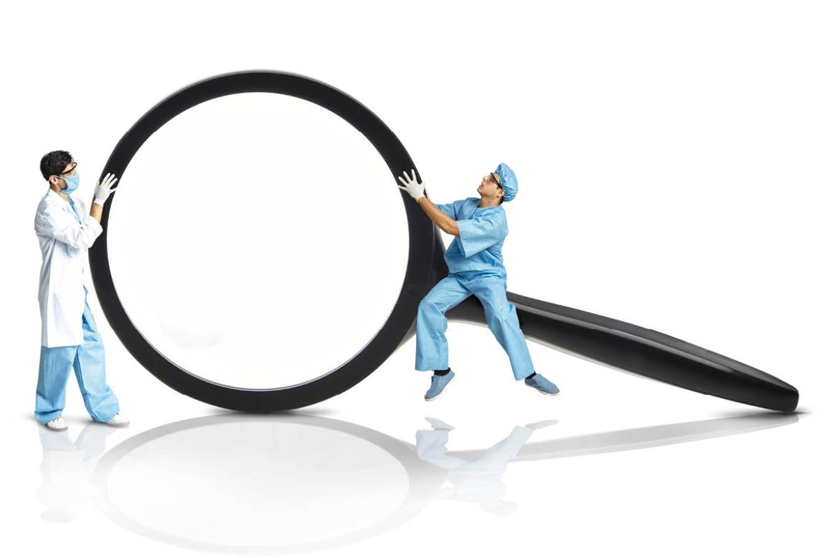 Graphic of two physicians holding a large magnifying glass