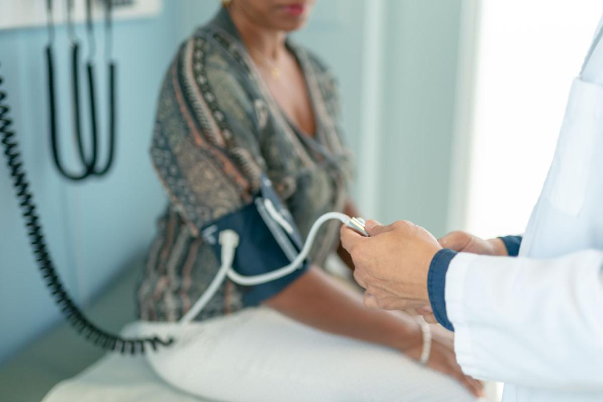 Patient having blood pressure measured in physician office