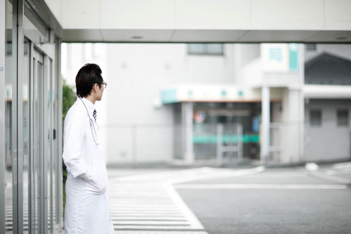 Physician standing outside looking away