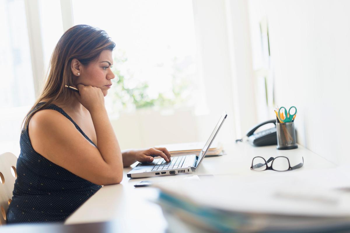 Woman intently working at a laptop