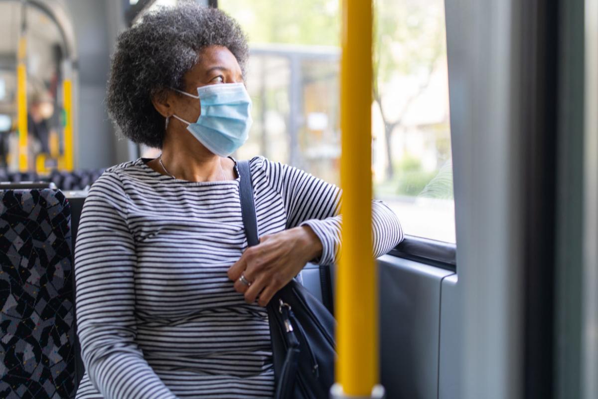 Person on a bus wearing a face mask