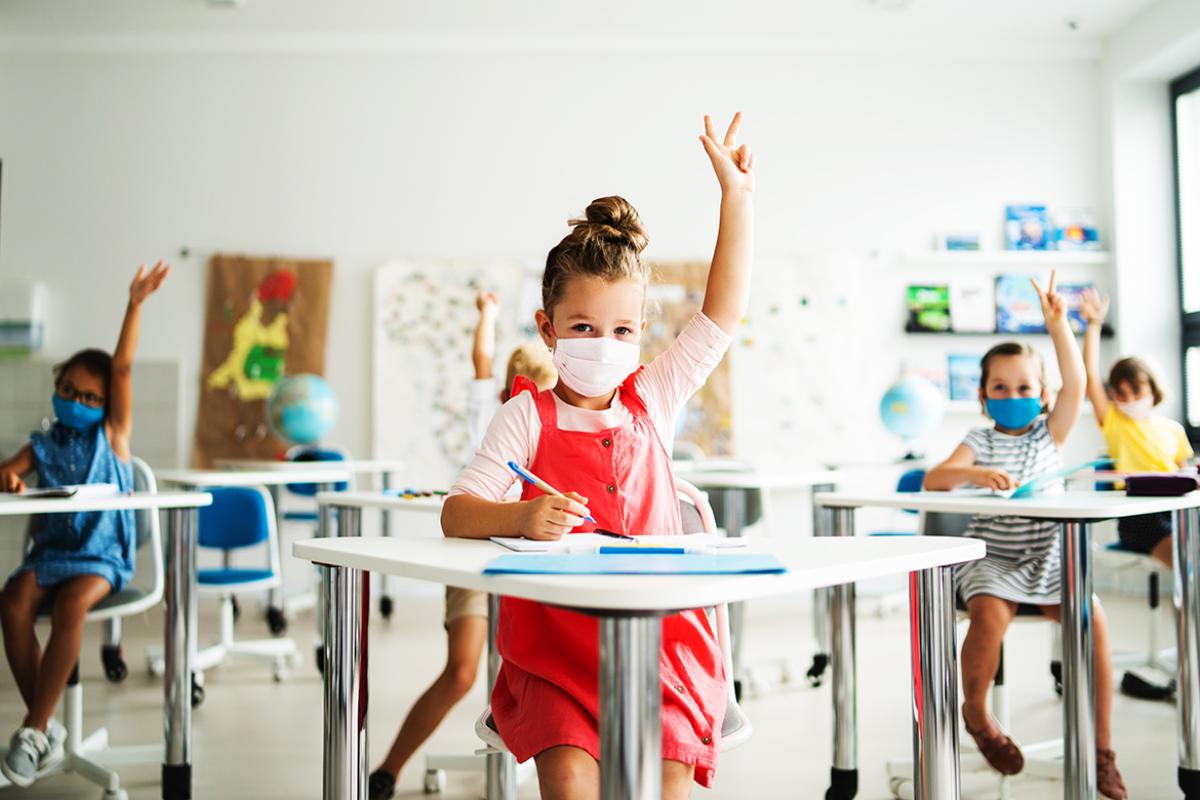 Child in classroom wearing a face mask.