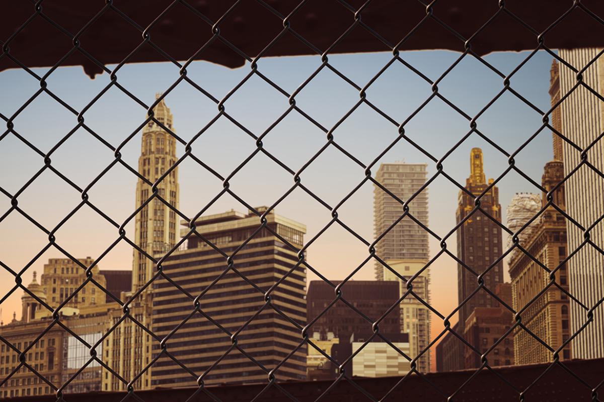 Chain link fence with cityscape