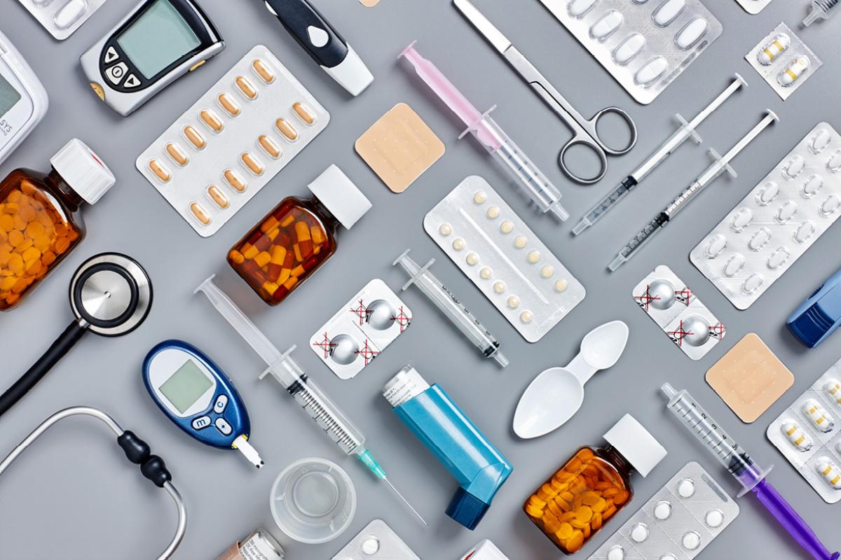 Variety of medications and medical instruments arranged in a patterned grid.