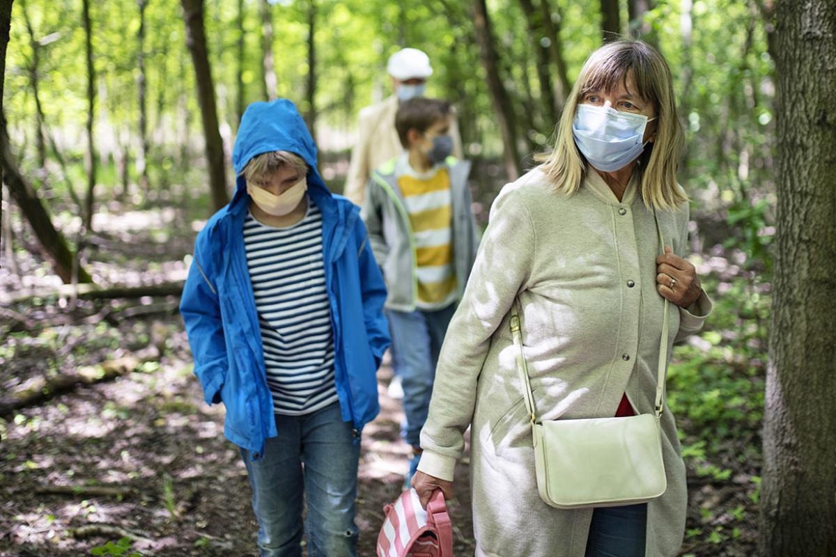 Family wearing face masks out for a walk