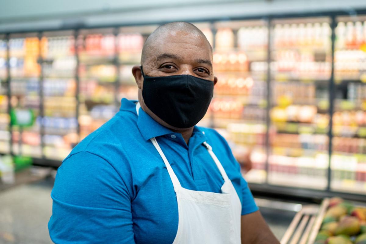 Grocery store employee with a mask