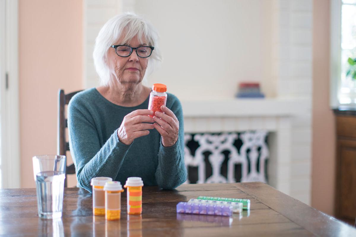 Older person looking at medication