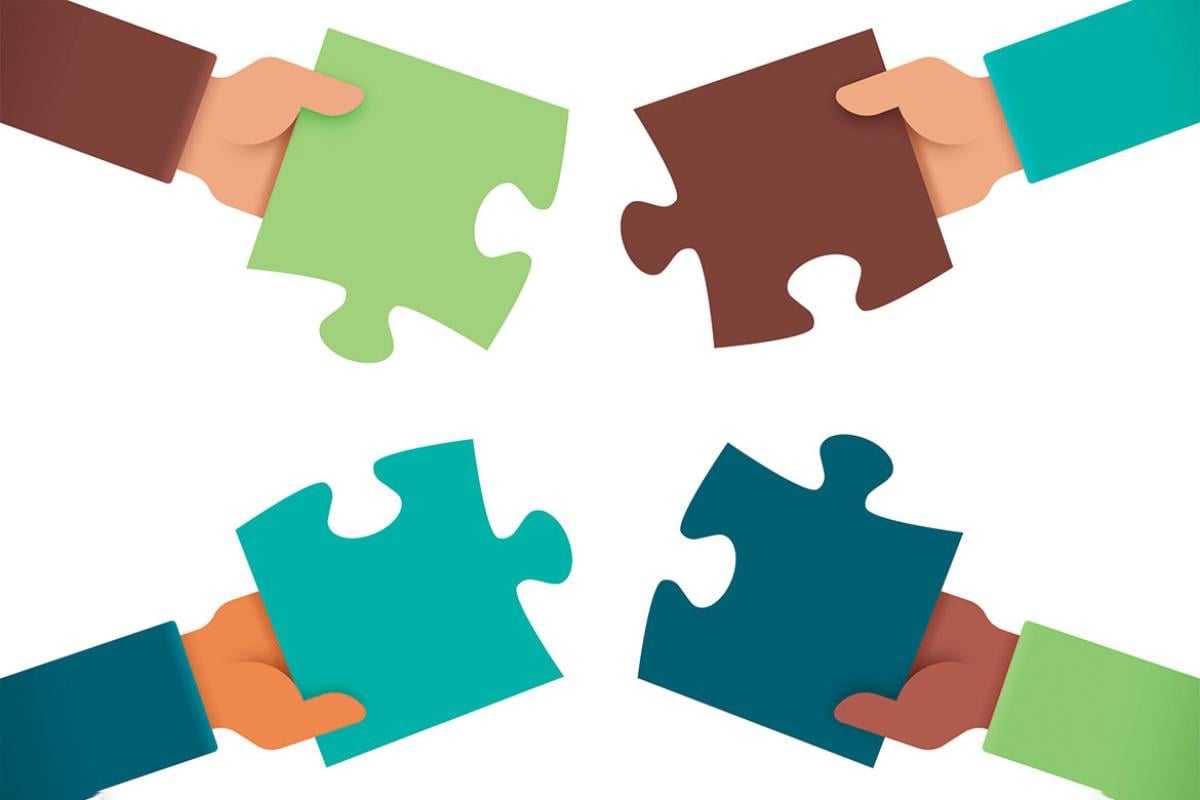 Four puzzle pieces being put together