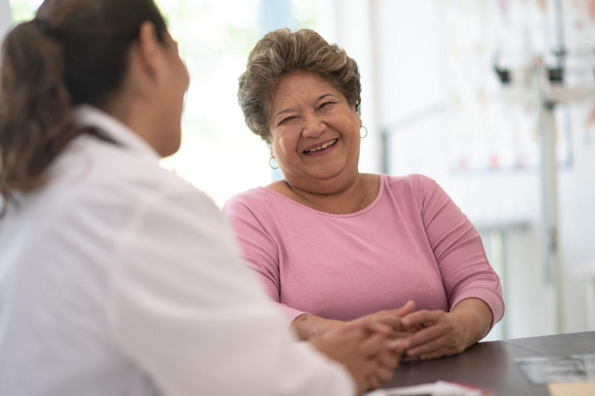 Smiling person in conversation with health care worker