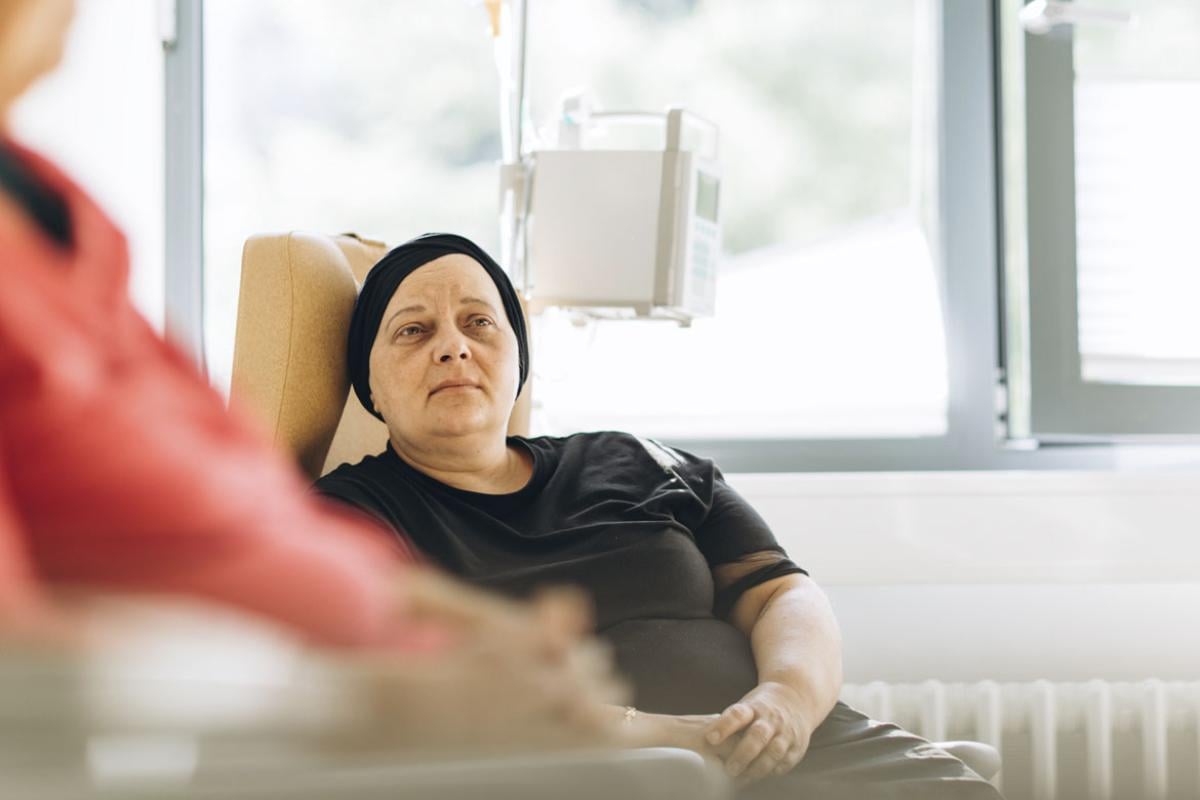 Patient in a headscarf sitting in a hospital