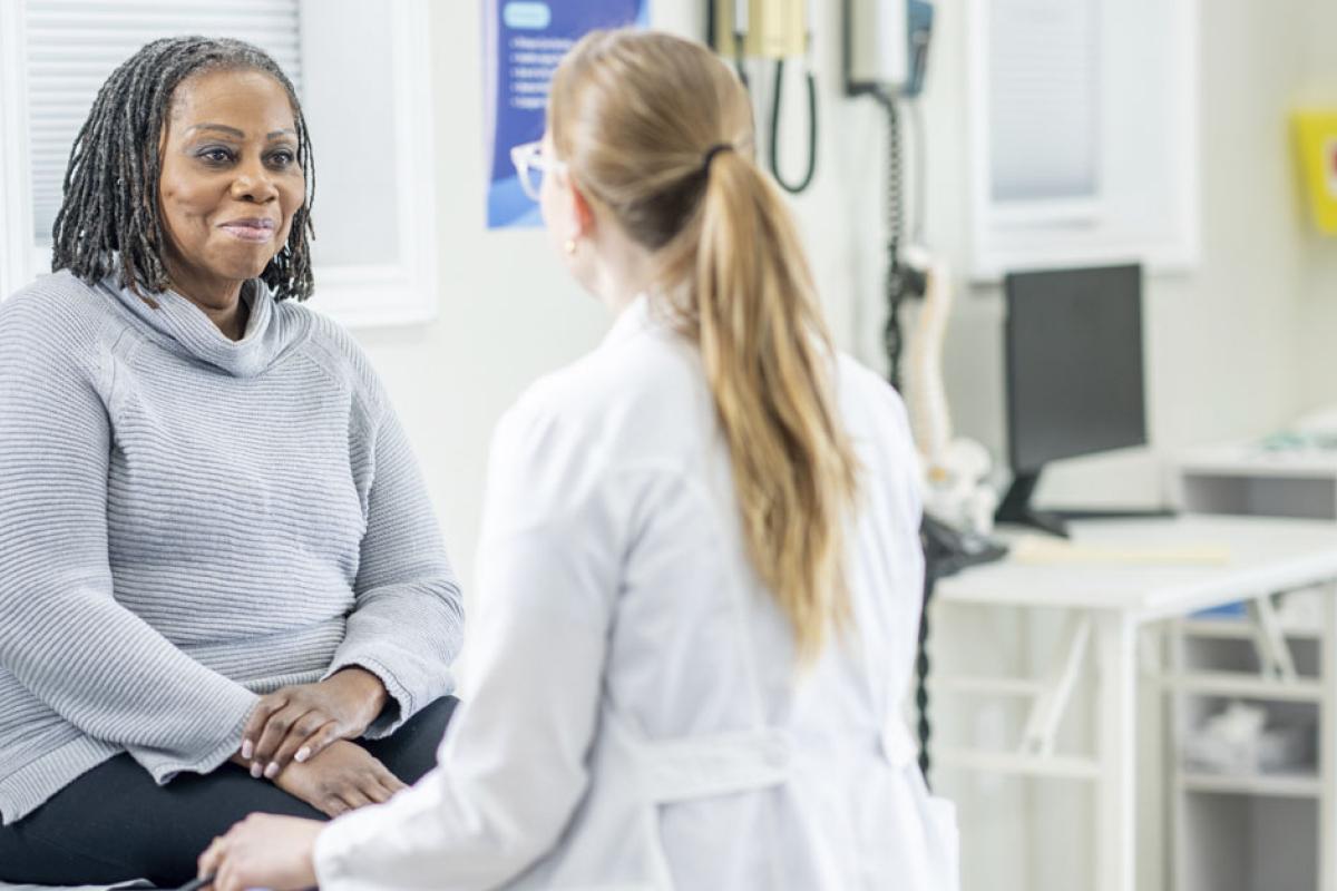 Smiling patient listens to physician during an appointment