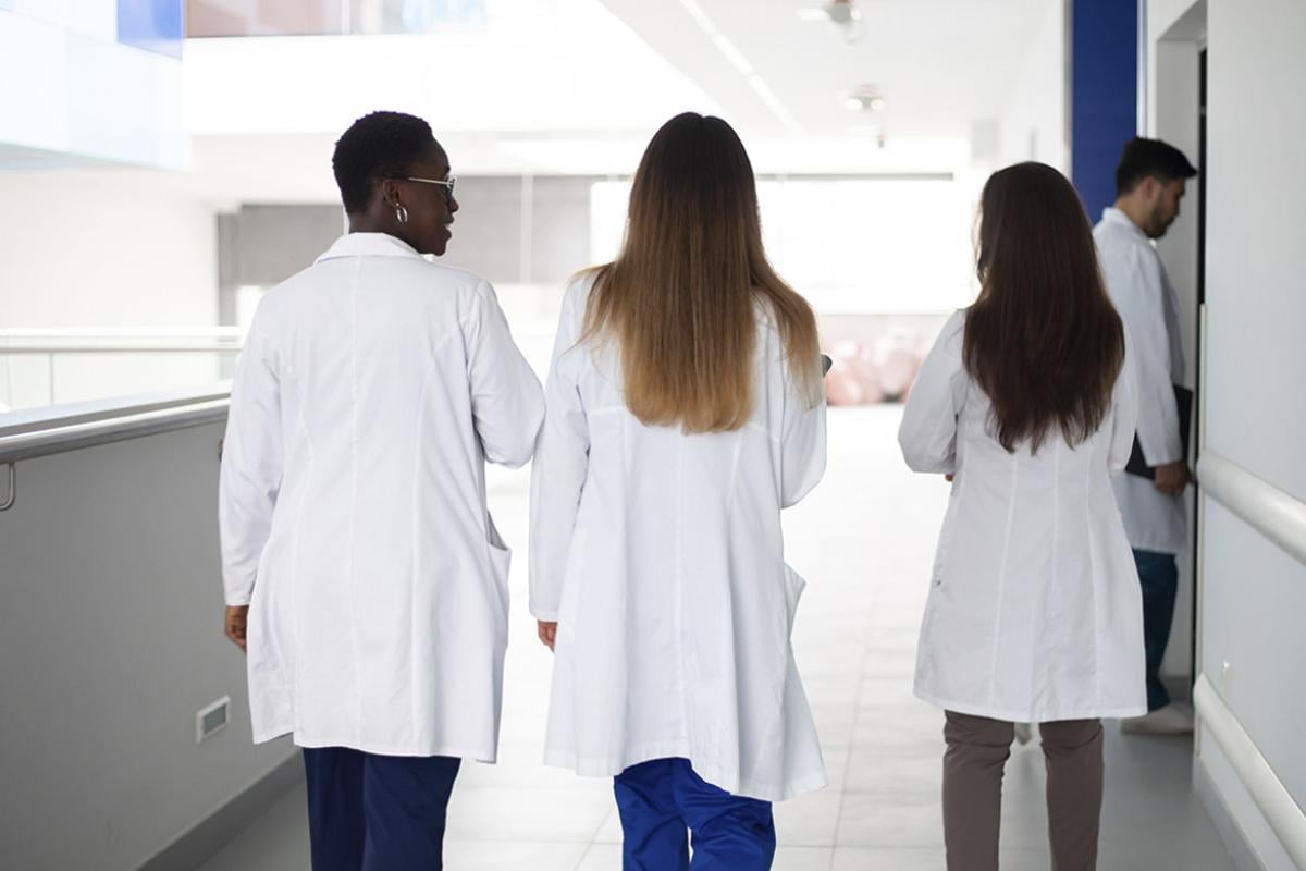 Group of physicians walking in hospital corridor 