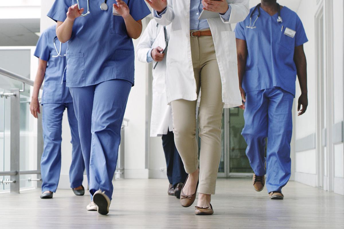 Group of health care workers walking down a hallway