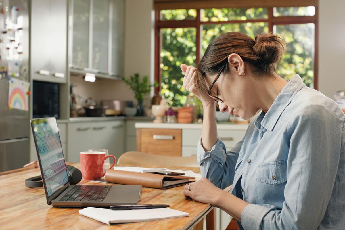 Frustrated woman with head in hand