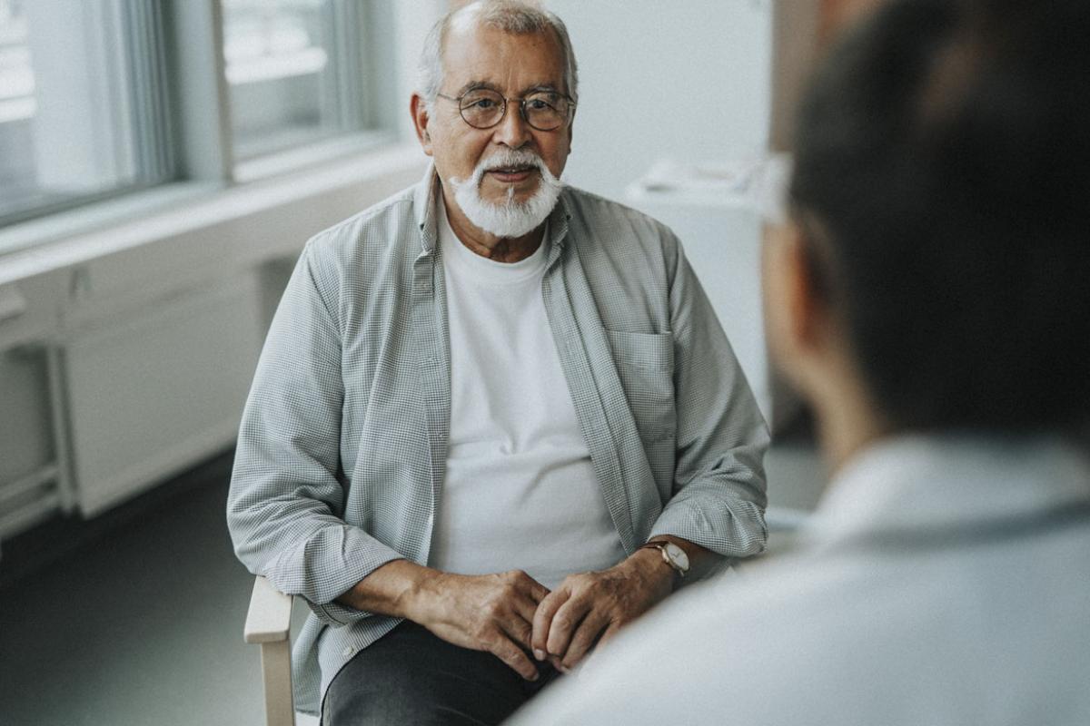 Senior patient sitting with doctor during consultation