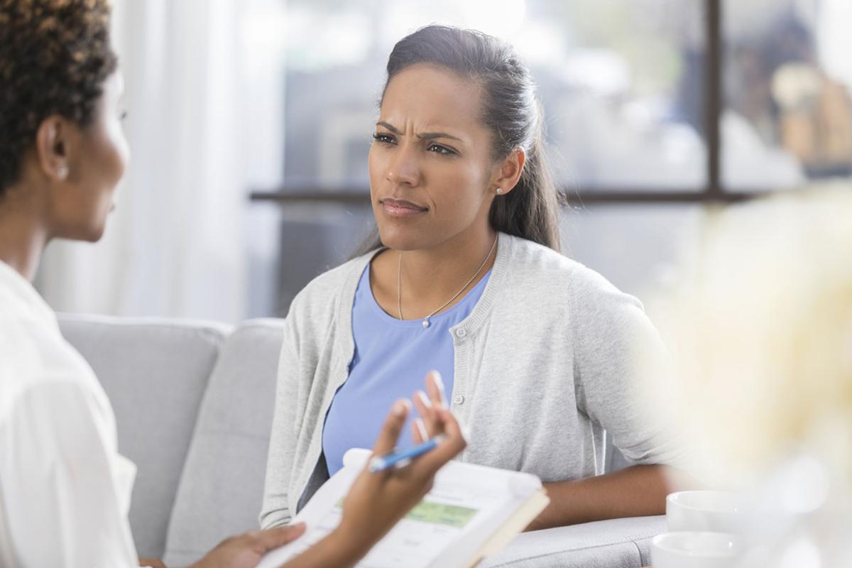 Confused woman listens to counselor 