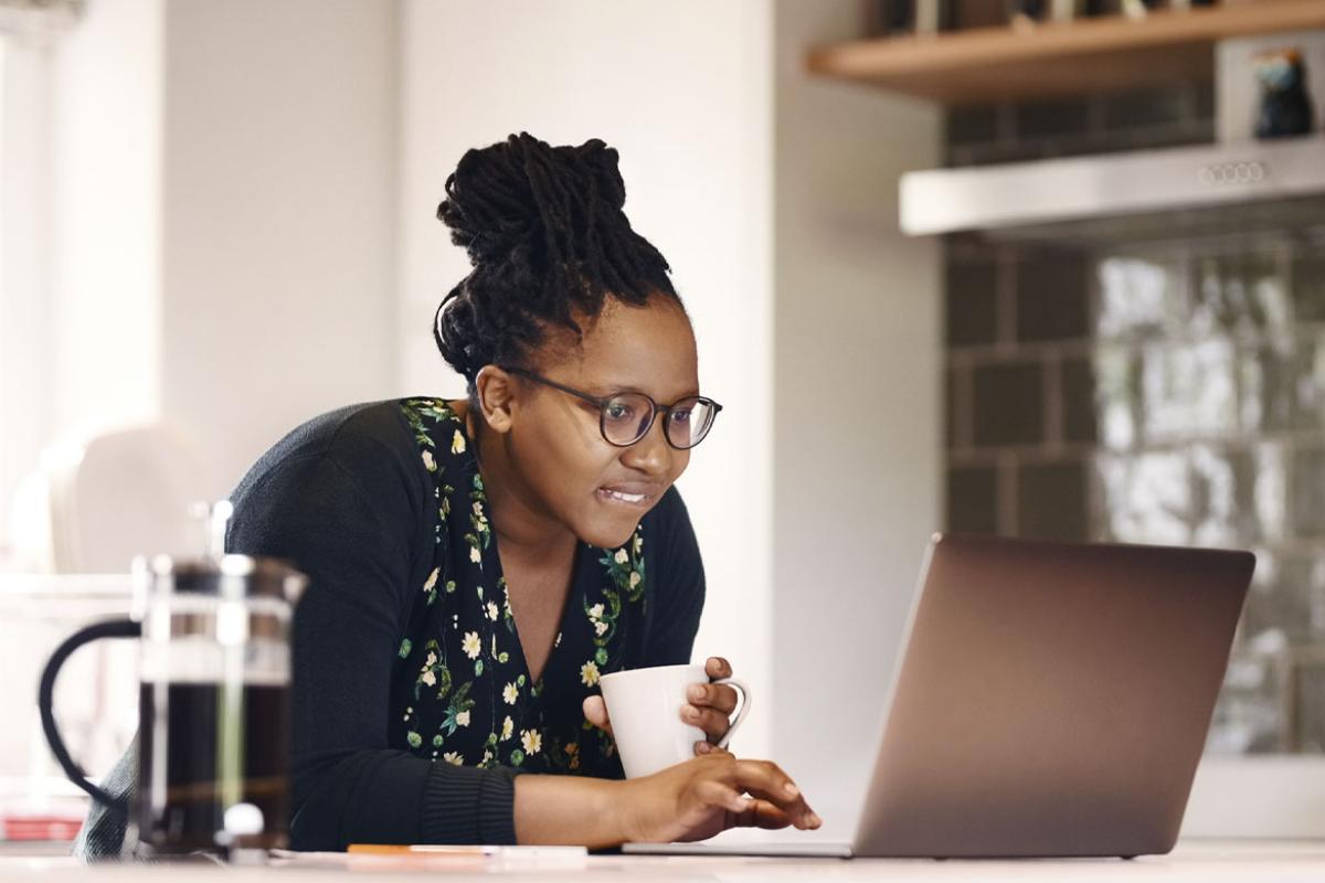 Woman with a concerned expression looks at laptop