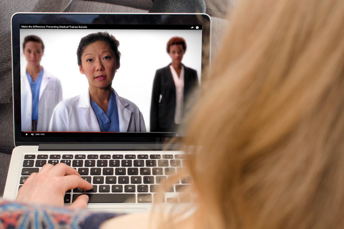 Person communicating with three physicians on a computer.