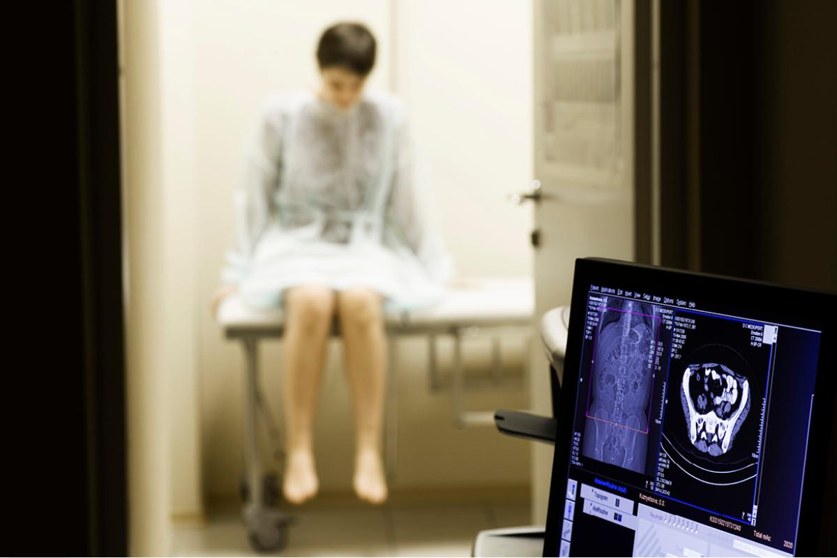Patient in hospital gown getting a scan.