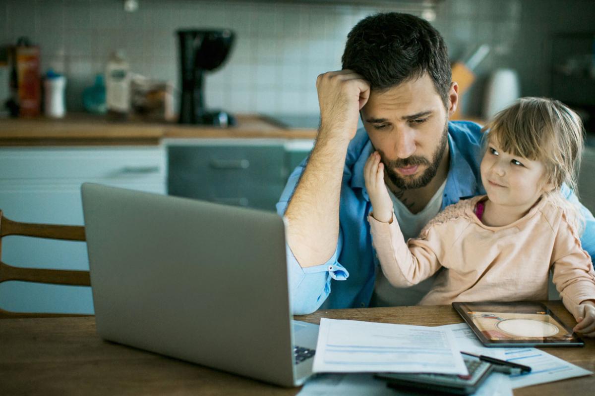 Dejected man and child looking at laptop 