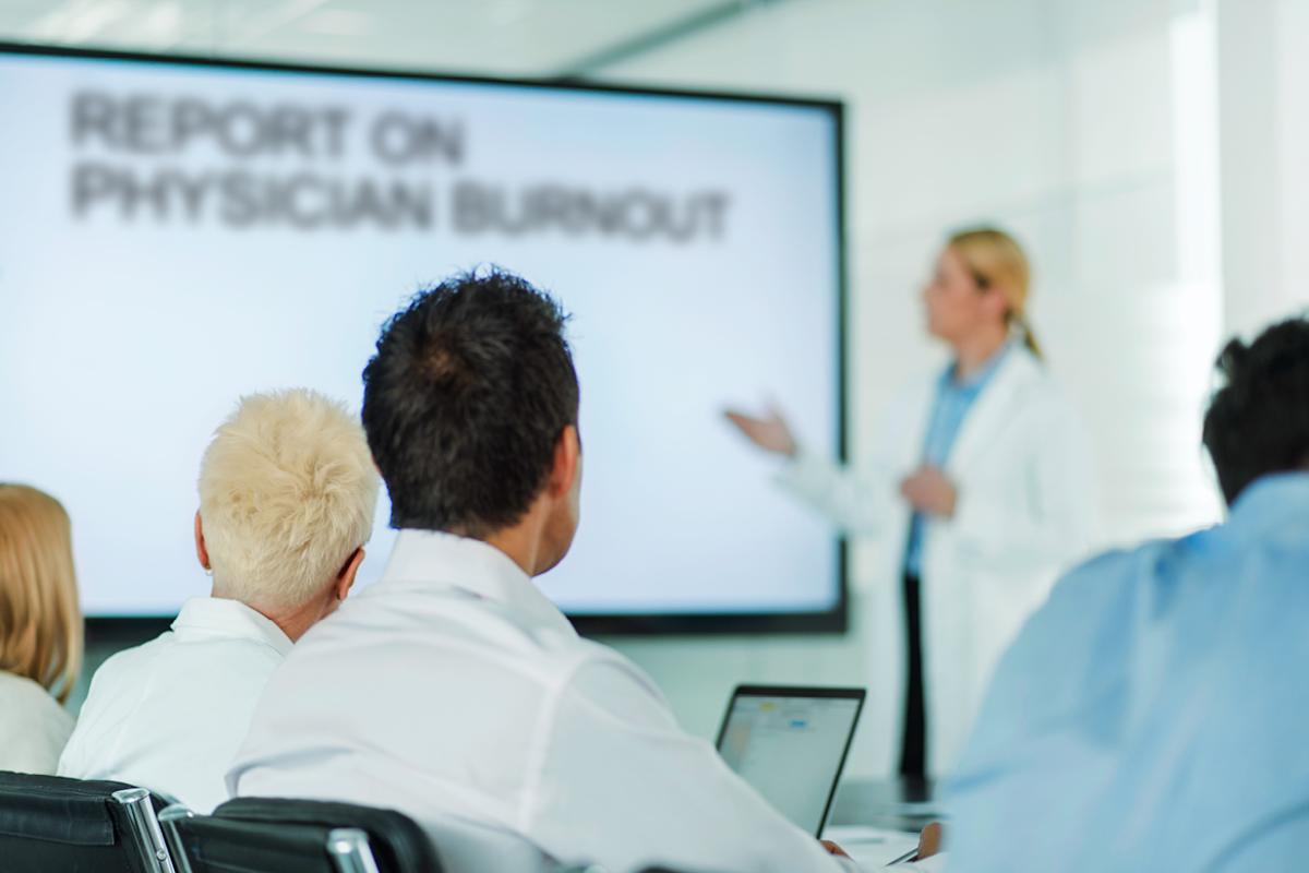 Physicians gathered in a classroom to learn about burnout. 