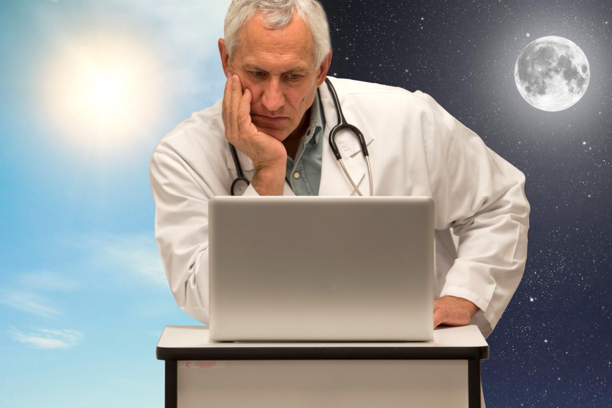 Doctor works day and night on electronic health records. 