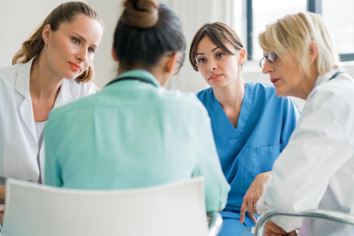 Four female physicians gather for consultation. 
