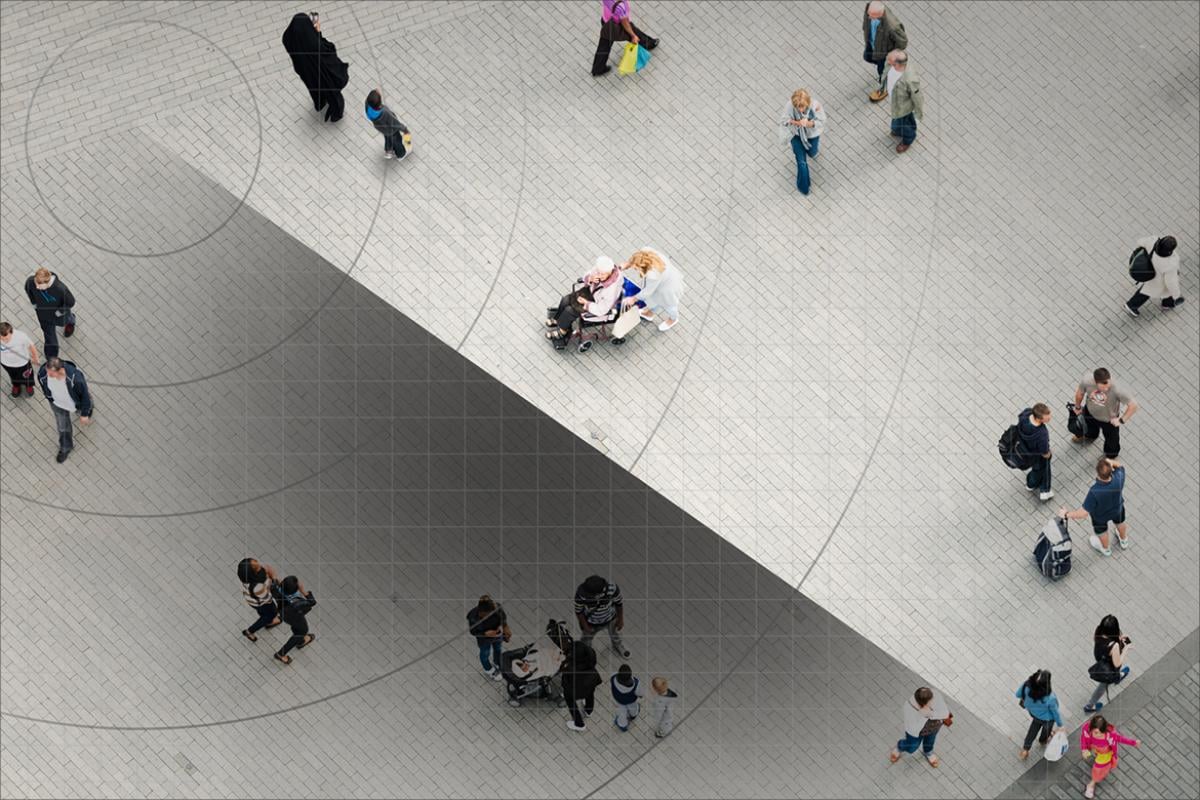 Overhead image of people walking in a crowd. 