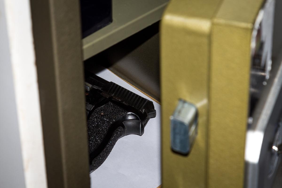 Hand gun inside an open safe. 