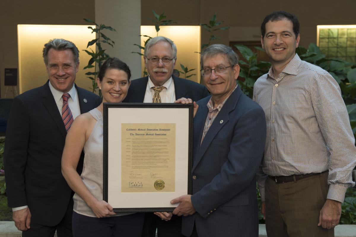 Members of the California Medical Association present Dr. Barbe with a resolution of gratitude.